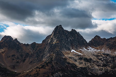 mountain summits under gray cloudy sky thumbnail