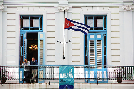 two person standing on balcony with flag thumbnail
