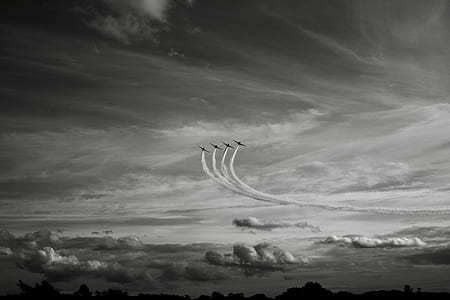four jet plane in sky with white smoke thumbnail