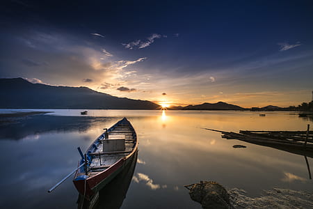 brown and black boat on body of water thumbnail