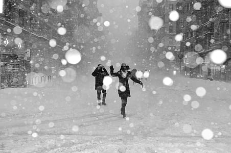 two person walking on snow covered floor thumbnail