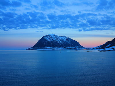 black mountain in front of body of water thumbnail
