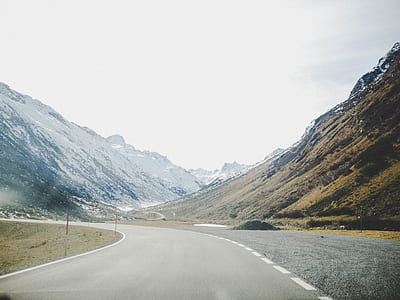 Gray Concrete Road Surrounded With Mountains thumbnail