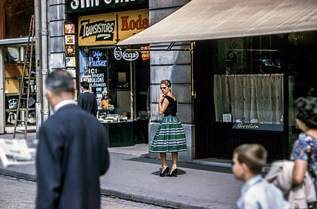 woman in green and white stripe skirt walking on sidewalk thumbnail