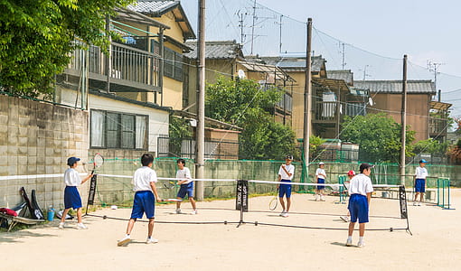 kids playing badminton during daytime thumbnail