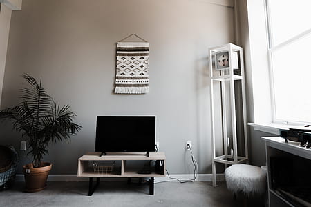 flat screen television on brown wooden sideboard turned off thumbnail