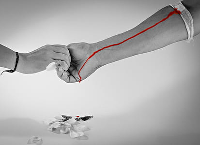 grayscale photography of two person holding hands thumbnail