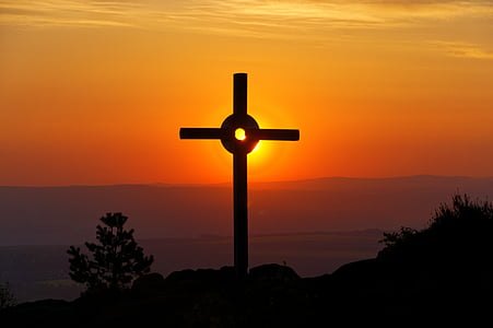silhouette photography of cross and orange sunset thumbnail
