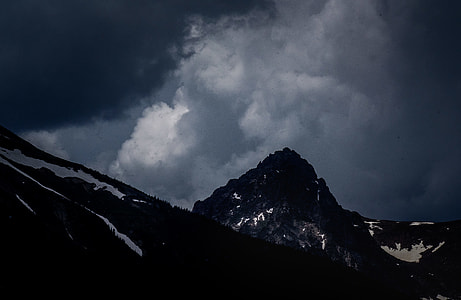 photography of mountain under cumulus clouds thumbnail
