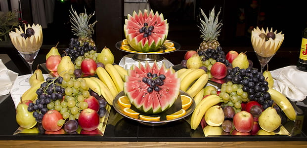 assorted fruit display and art on black table closeup photo thumbnail
