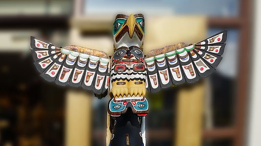 selective focus photograph of multicolored tribal eagle sculpture thumbnail
