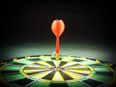 orange arrow on dartboard closeup photo thumbnail
