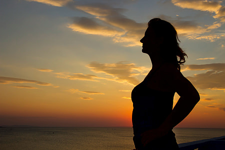 woman facing the ocean during golden hour thumbnail