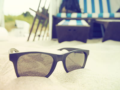 Selective Focus Photography of Black-framed Sunglasses on Sand thumbnail