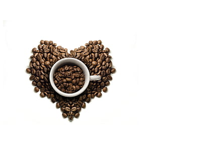 white ceramic coffee mug on coffee beans shaping at heart thumbnail