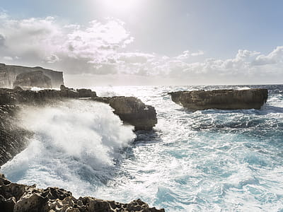 Brown Rock Formations Surrounded by Body of Water thumbnail
