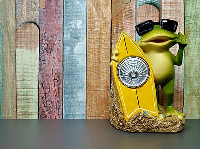 frog holding surfboard ceramic figurine thumbnail