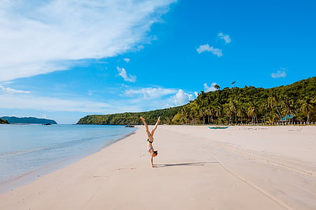 woman standing on hands on beach thumbnail