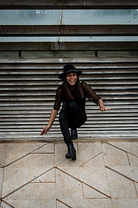 woman leaning on gray wall thumbnail