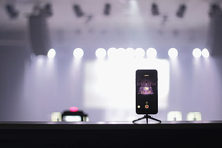 phone placed on stage with stand while recording thumbnail
