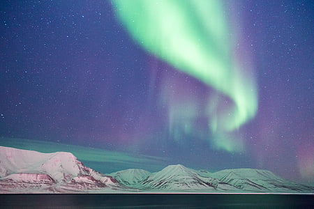 hills under Aurora Borealis lights photo thumbnail