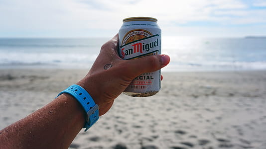 Person Holding San Miguel Beer Tin Can thumbnail