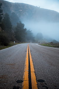 gray concrete road near mountain thumbnail