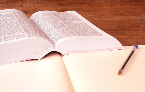 open book near blue ballpoint pen thumbnail