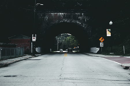 Cars on Road Under Tunnel during Daytime thumbnail
