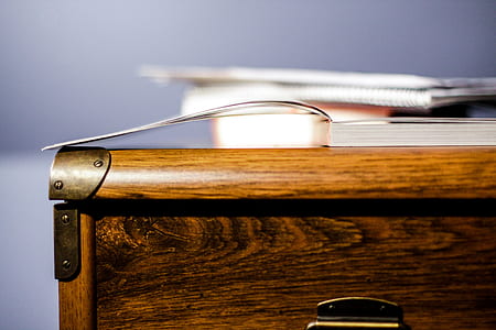 book on brown wooden desk thumbnail