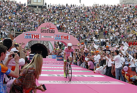 man riding bicycle in front of crowd people at daytime thumbnail