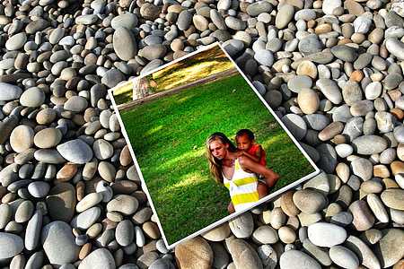 woman carrying child photo on the stones thumbnail