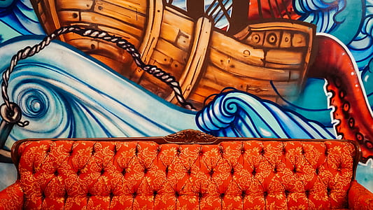 brown chesterfield sofa on painted wall thumbnail