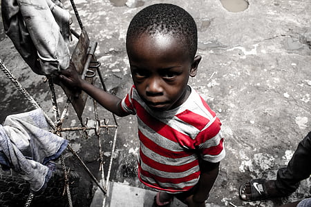 boy wearing red and white shirt selective color photography thumbnail