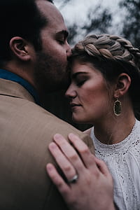 man kissing woman's forehead thumbnail