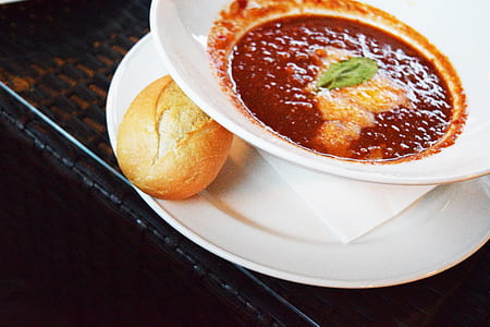 sauce on ceramic bowl beside bread thumbnail