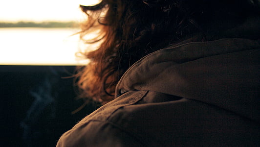 close-up photography of person wearing brown hoodie thumbnail