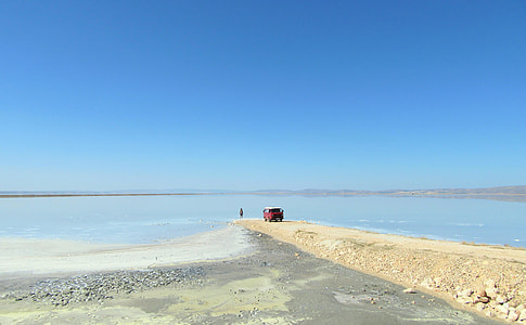landscape photography of vehicle near seashore thumbnail