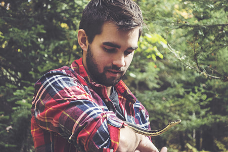 selective focus photo of man playing snake thumbnail