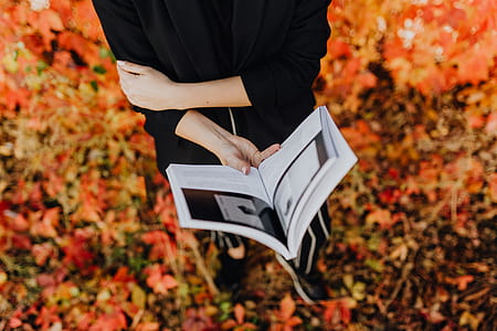 Girl with the Grafconf book on the background of colourful leaves thumbnail