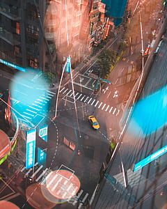 aerial view of yellow car on road during daytime thumbnail