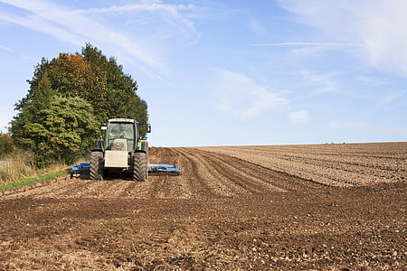 farm tractor plowing the soil at the farm thumbnail