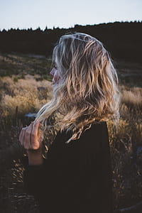 woman holding her hair at daytime thumbnail