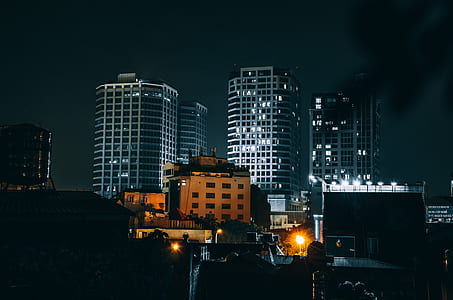 black and gray concrete buildings during night time thumbnail