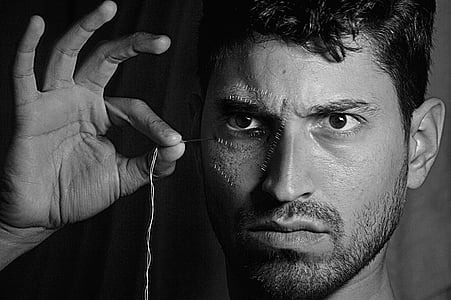 man holding thread thumbnail