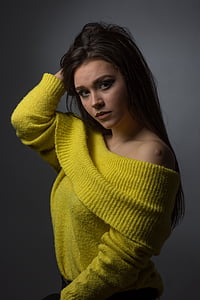 woman wearing yellow off-shoulder top holding her hair thumbnail