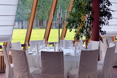 white chairs around white table thumbnail