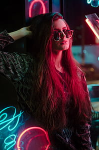woman with sunglasses leaning on wall thumbnail