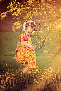 girl wearing yellow and red floral dress thumbnail