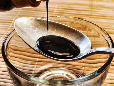 black liquid poured on spoon thumbnail